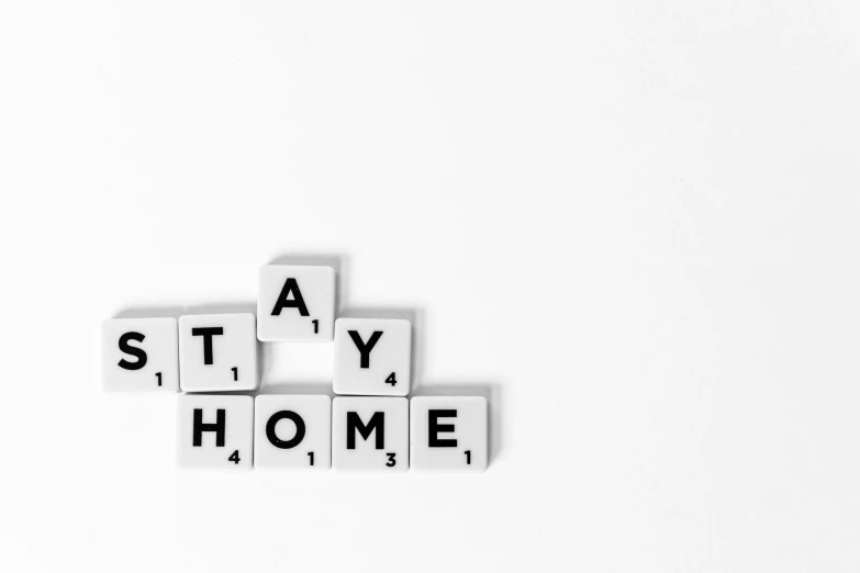 the word stay home spelled in scrabbles on a white surface, a black and white photo, by Nicolette Macnamara, pixabay, fine art, jovana rikalo, flat style, tiny house, gamer aesthetic