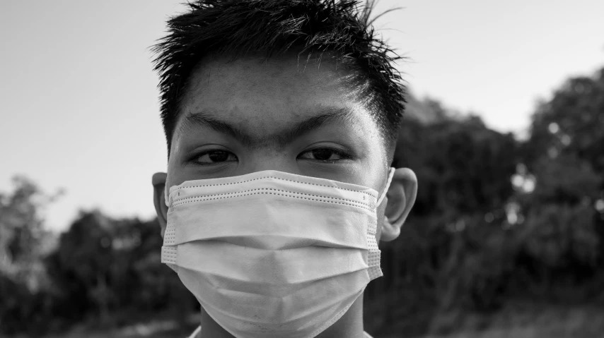 a close up of a person wearing a face mask, a black and white photo, pexels, shin hanga, peruvian boy looking, olchas logan cure liang xing, portrait of a big, high quality upload