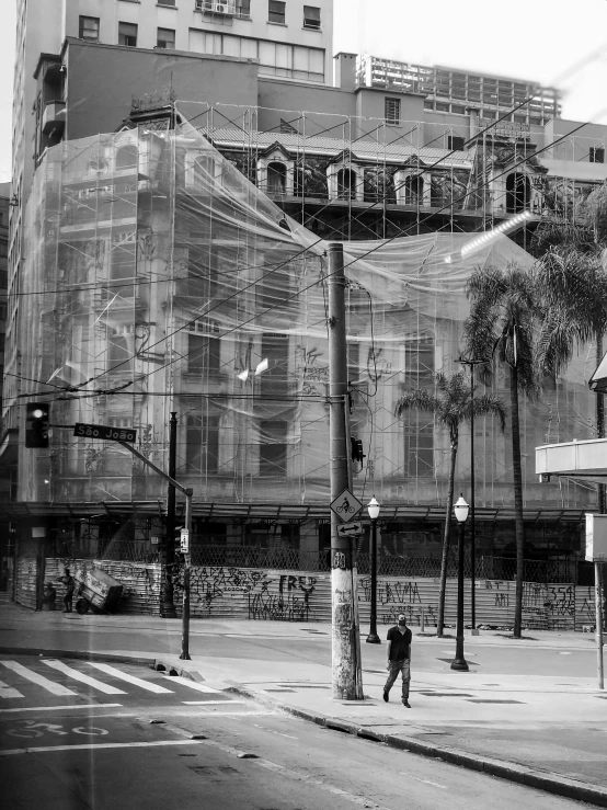 a black and white photo of a city street, temporary art, transparent building, sao paulo, the the man is wrapped in chains, photo taken in 2 0 2 0