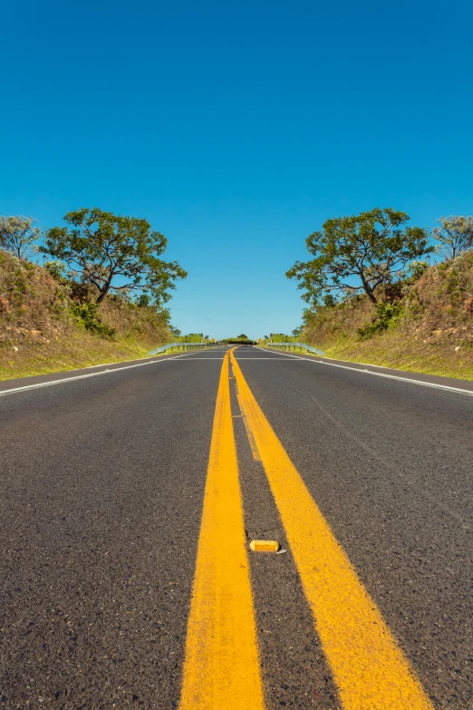 a yellow line in the middle of a road, an album cover, hawaii, ultrawide image, 2019 trending photo, extreme panoramic