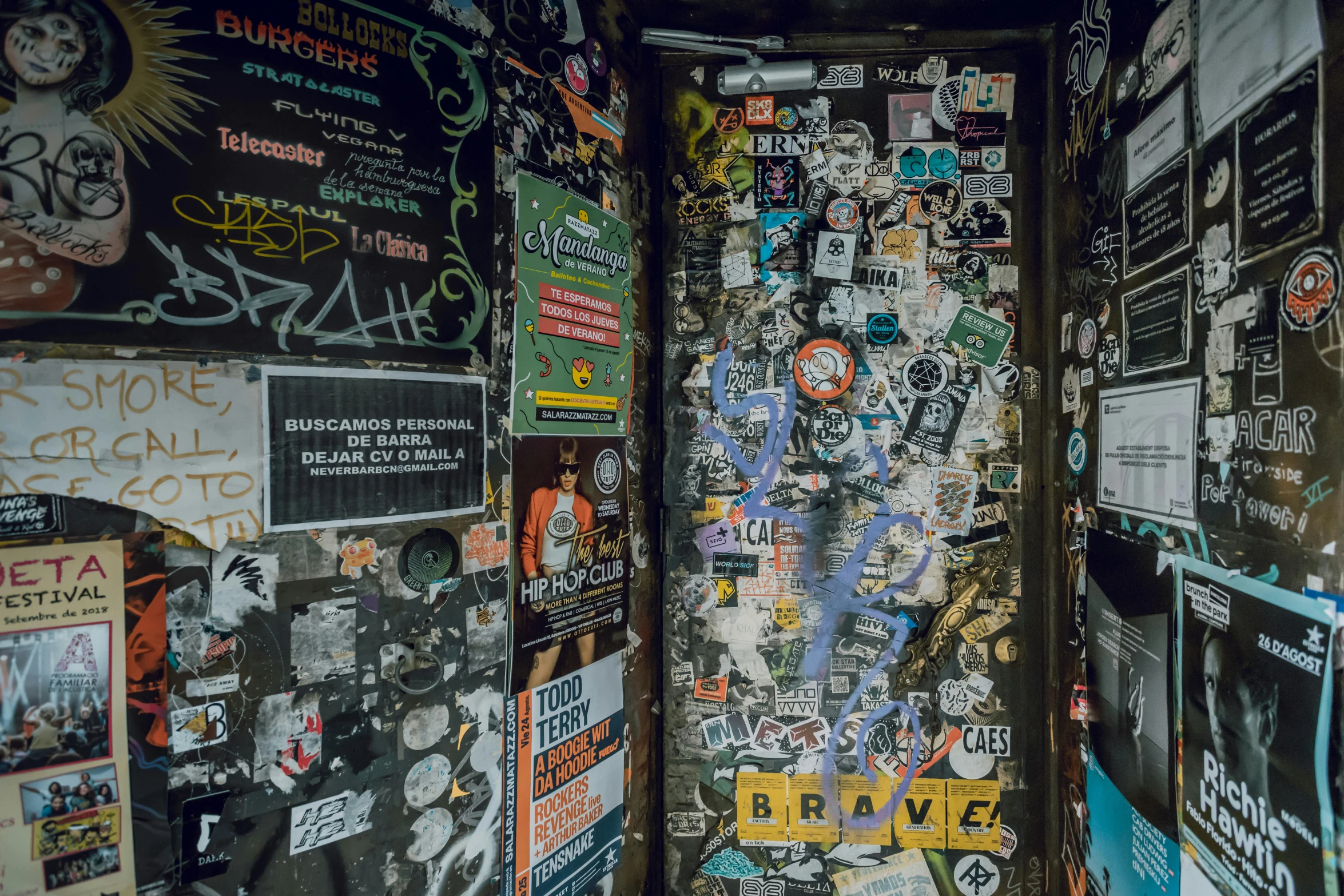 a door that has a bunch of stickers on it, by Elsa Bleda, pexels, graffiti, inside a bar, 256x256, revolutionary, space station vore station