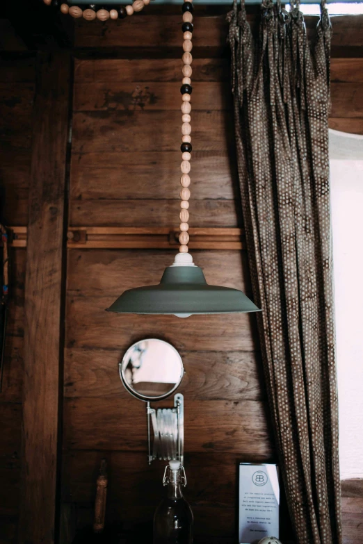 a lamp hanging from the side of a wooden wall, a portrait, unsplash, beaded curtains, sink, angled shot, item