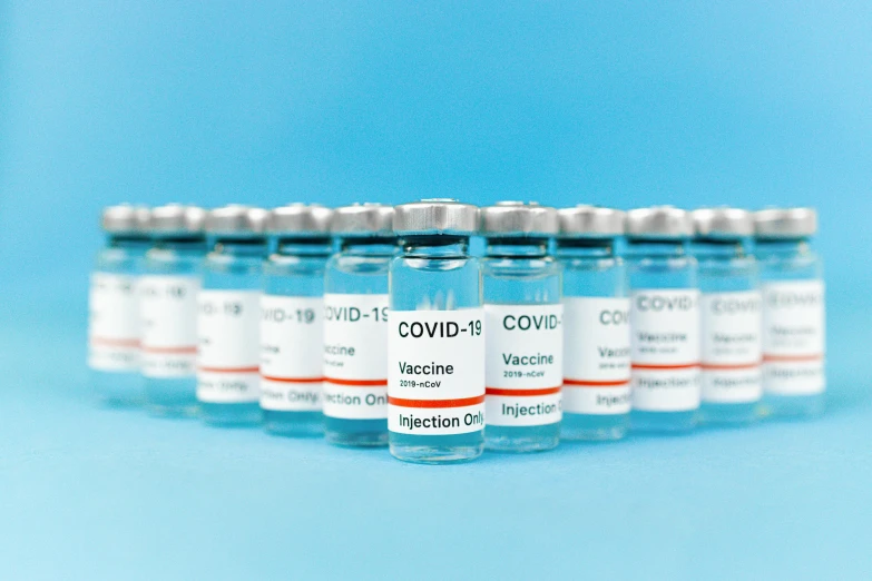 a row of vials filled with vaccines, a picture, shutterstock, visual art, instagram post, sky blue, colour corrected, silver