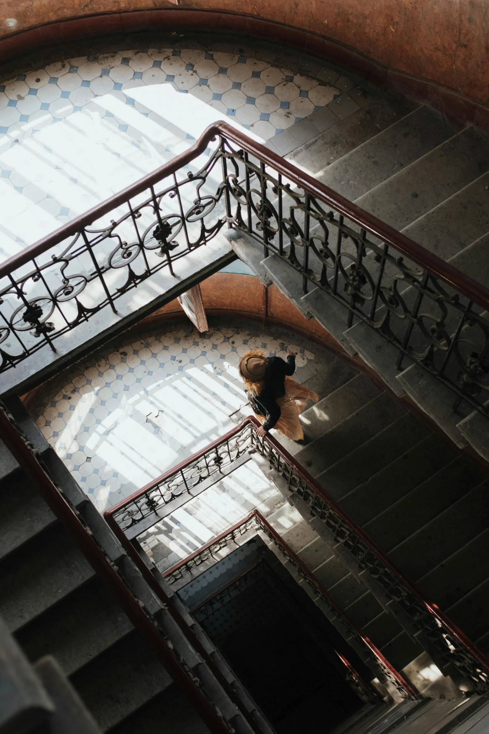 a person walking down a set of stairs, inspired by Elsa Bleda, unsplash contest winner, art nouveau, high view, dapped light, student, sprawling