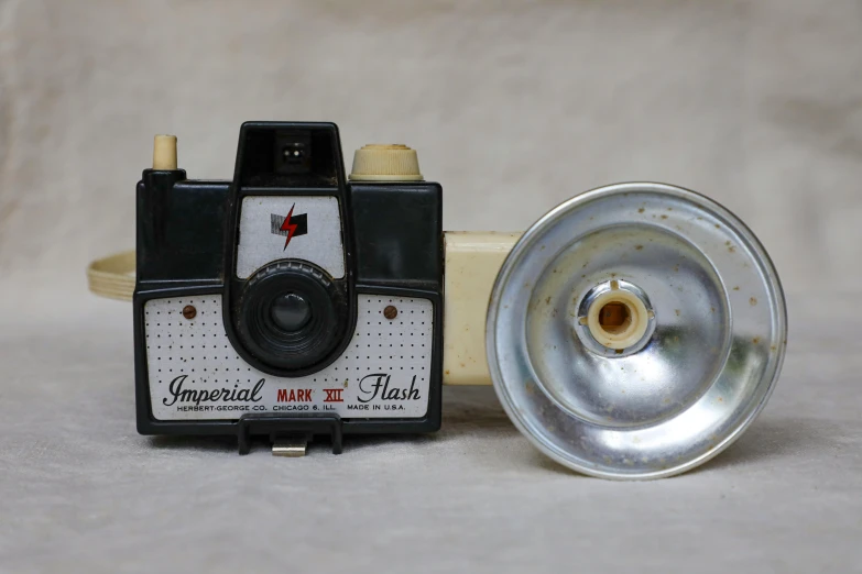 a close up of a camera on a table, inspired by Diane Arbus, bauhaus, bright camera flash enabled, imperial, etsy, 3 4 5 3 1