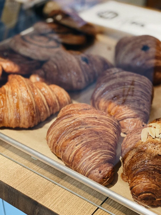 a tray of croissants sitting on top of a counter, jen atkin, momoshiki ōtsutsuki, chocolate, thumbnail