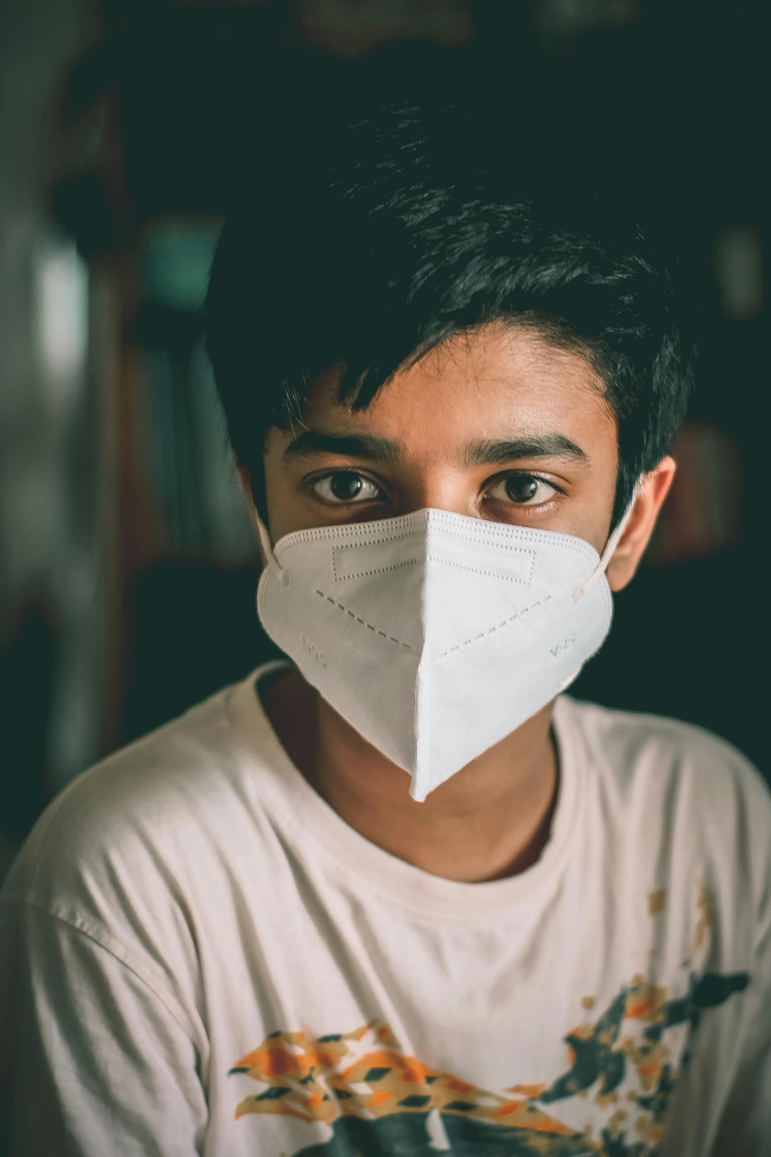 a close up of a person wearing a face mask, a picture, he is about 20 years old | short, coronavirus, indian, confident looking