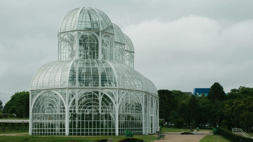 a large white building sitting on top of a lush green field, inspired by Thomas Struth, pexels contest winner, art nouveau, glass greenhouse, buenos aires, hexadome, against a winter garden