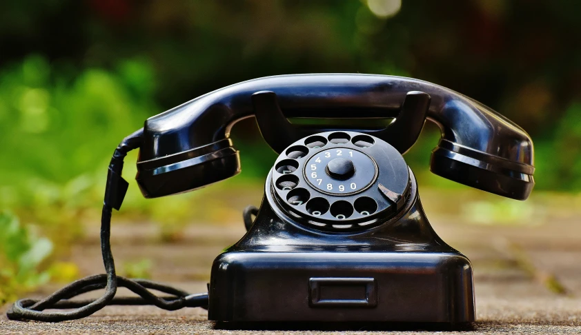a black telephone sitting on top of a sidewalk, 15081959 21121991 01012000 4k, vintage theme, technological rings, profile picture 1024px