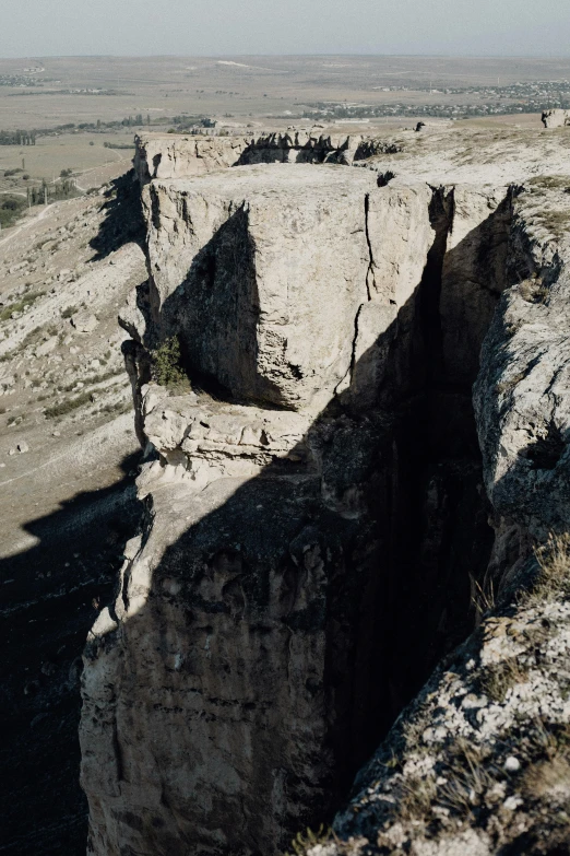 a group of people standing on top of a cliff, sinkholes, wyoming, dry archways, very cinematic