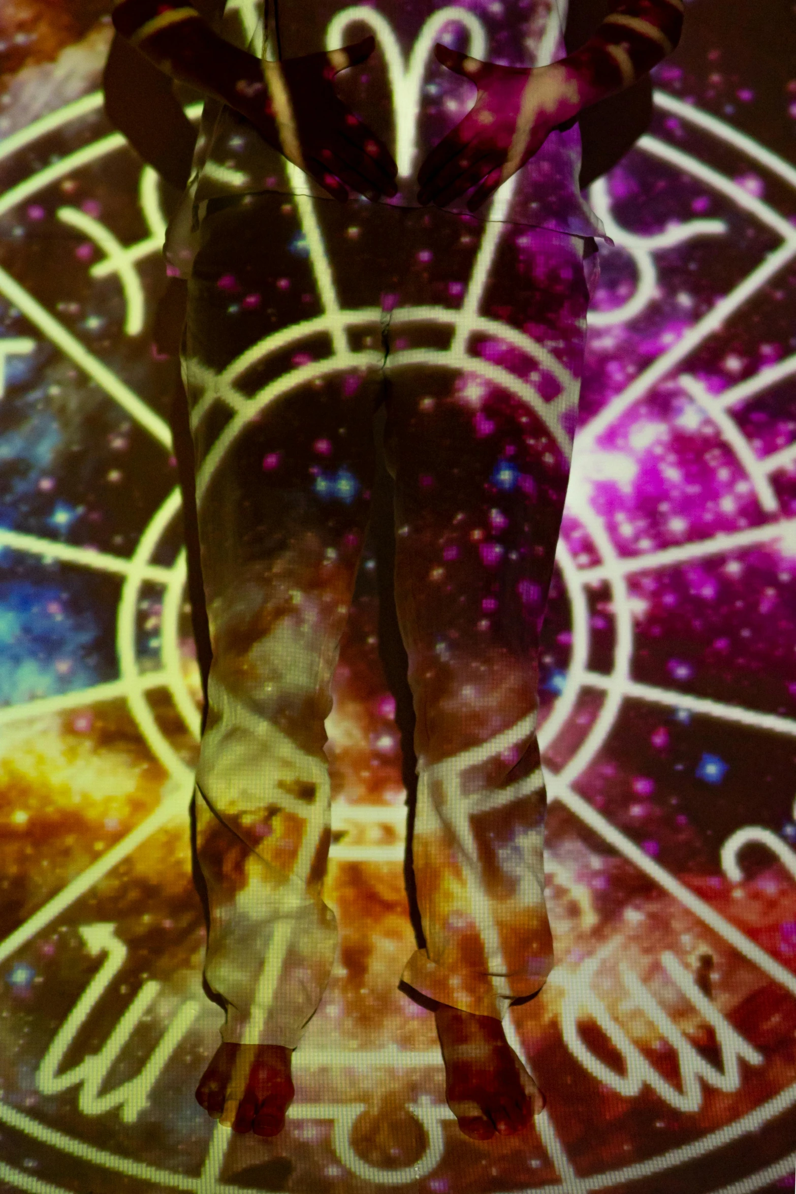 a man that is standing in front of a clock, by Gwen Barnard, trending on pexels, holography, white tights covered in stars, wearing psychedelic wicca, close-up on legs, banner