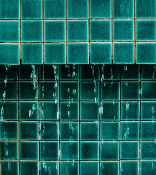 a fire hydrant sitting in front of a tiled wall, inspired by Elsa Bleda, unsplash, modernism, flowing teal-colored silk, glazed ceramic, carnal ) wet, walter gropius