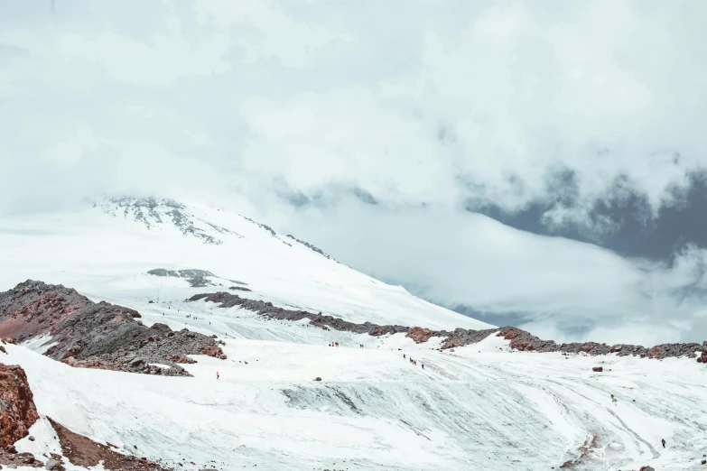 a man riding a snowboard down a snow covered slope, an album cover, trending on unsplash, hurufiyya, andres gursky, panorama view, chile, on a cloudy day