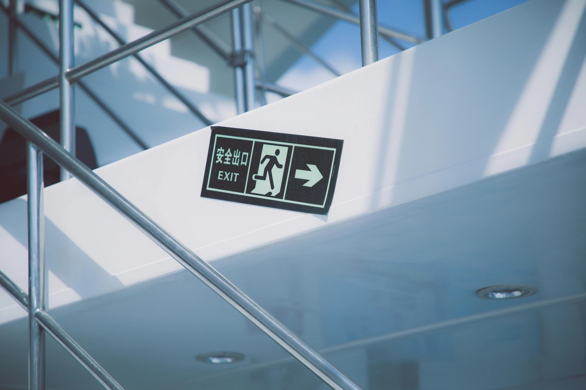 a close up of a sign on a stair case, pexels, happening, square, exit light, on ship, symbols