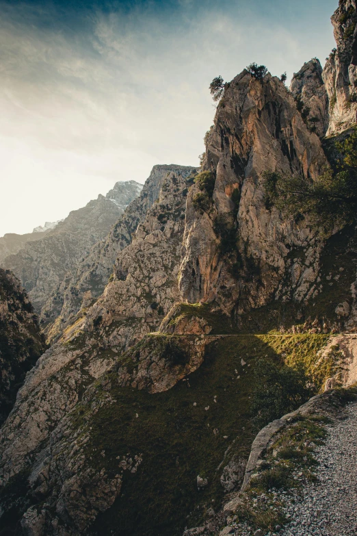 a man riding a bike down the side of a mountain, les nabis, 8k 28mm cinematic photo, mediterranean, multiple stories, unsplash 4k