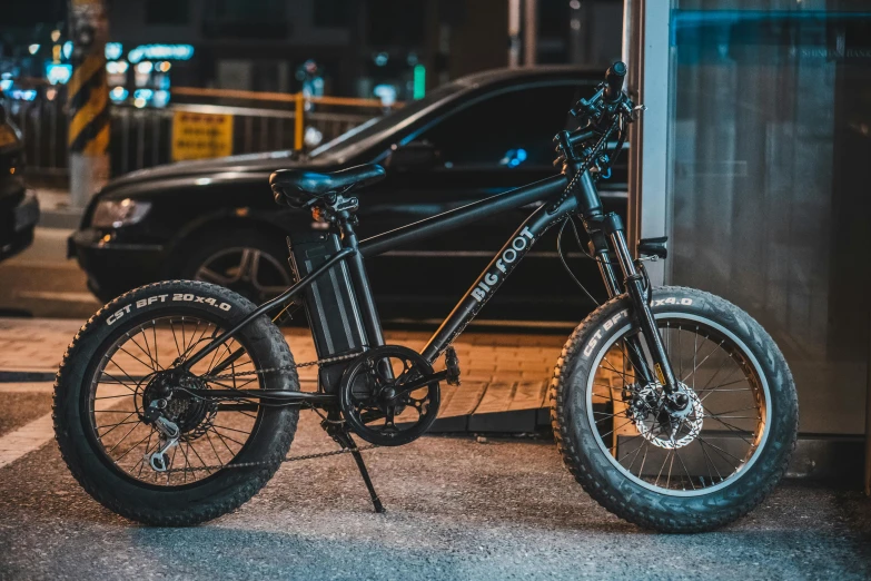 a bicycle parked on the side of a street, bigfoot, profile image, black, electric