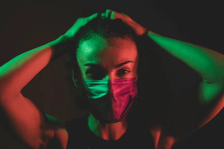 a woman wearing a face mask in the dark, pexels contest winner, green and pink, avatar image, green and red tones, bisexual lighting