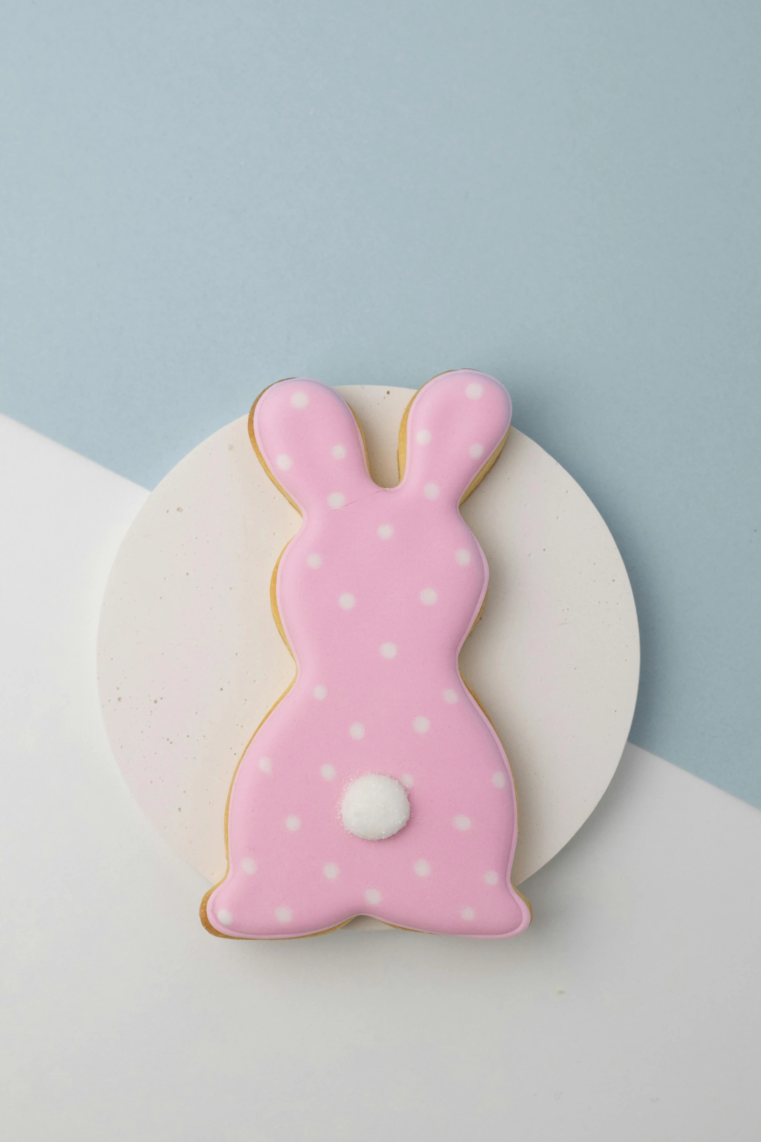 a pink bunny cookie sitting on top of a white plate, inspired by david rubín, polka dot, large tail, detailed product shot, 3156350975