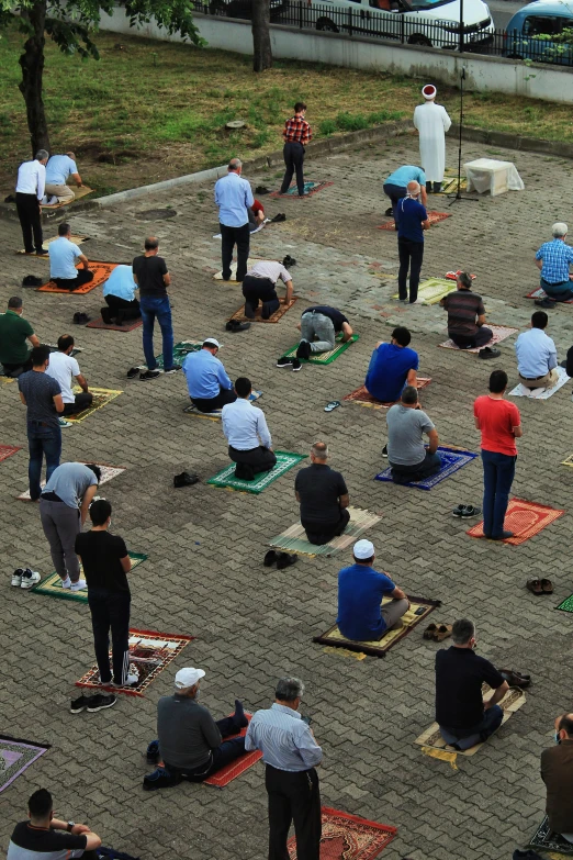 a group of people doing yoga in a park, hurufiyya, trump praying in mosque, photograph credit: ap, bosnian, square