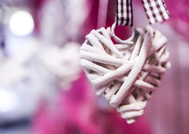 a close up of a heart made of sticks, by Sylvia Wishart, pexels contest winner, romanticism, white ceramic shapes, ribbon, white and pink, festive atmosphere