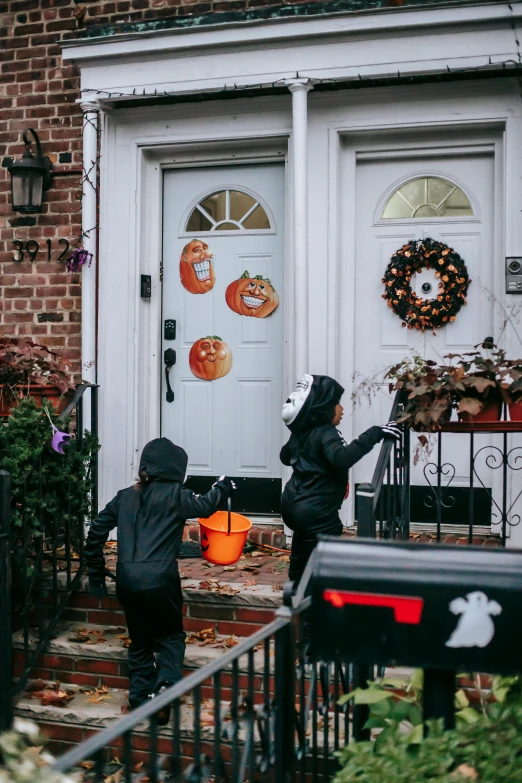 a couple of kids standing in front of a house, halloween decorations, attacking nyc, profile image, about to enter doorframe