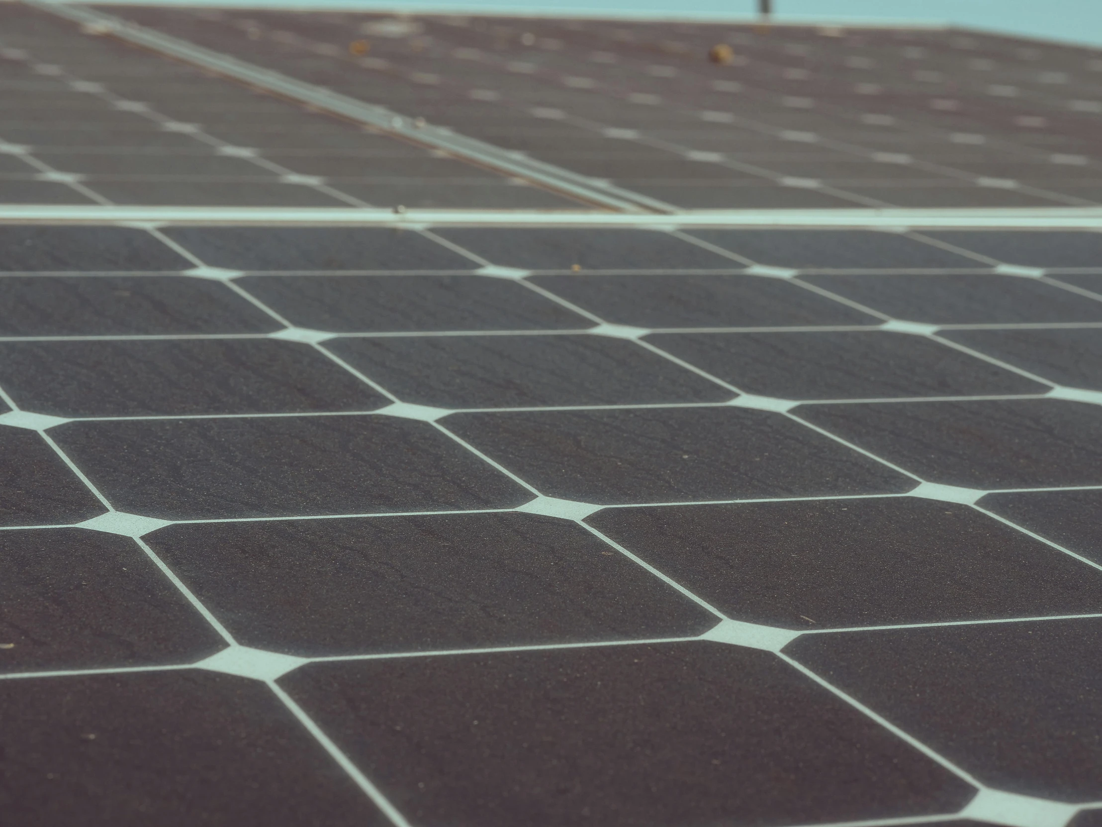 a close up of a solar panel on a roof, by Carey Morris, unsplash, bauhaus, grainy photorealistic, square lines, on ground, ignant