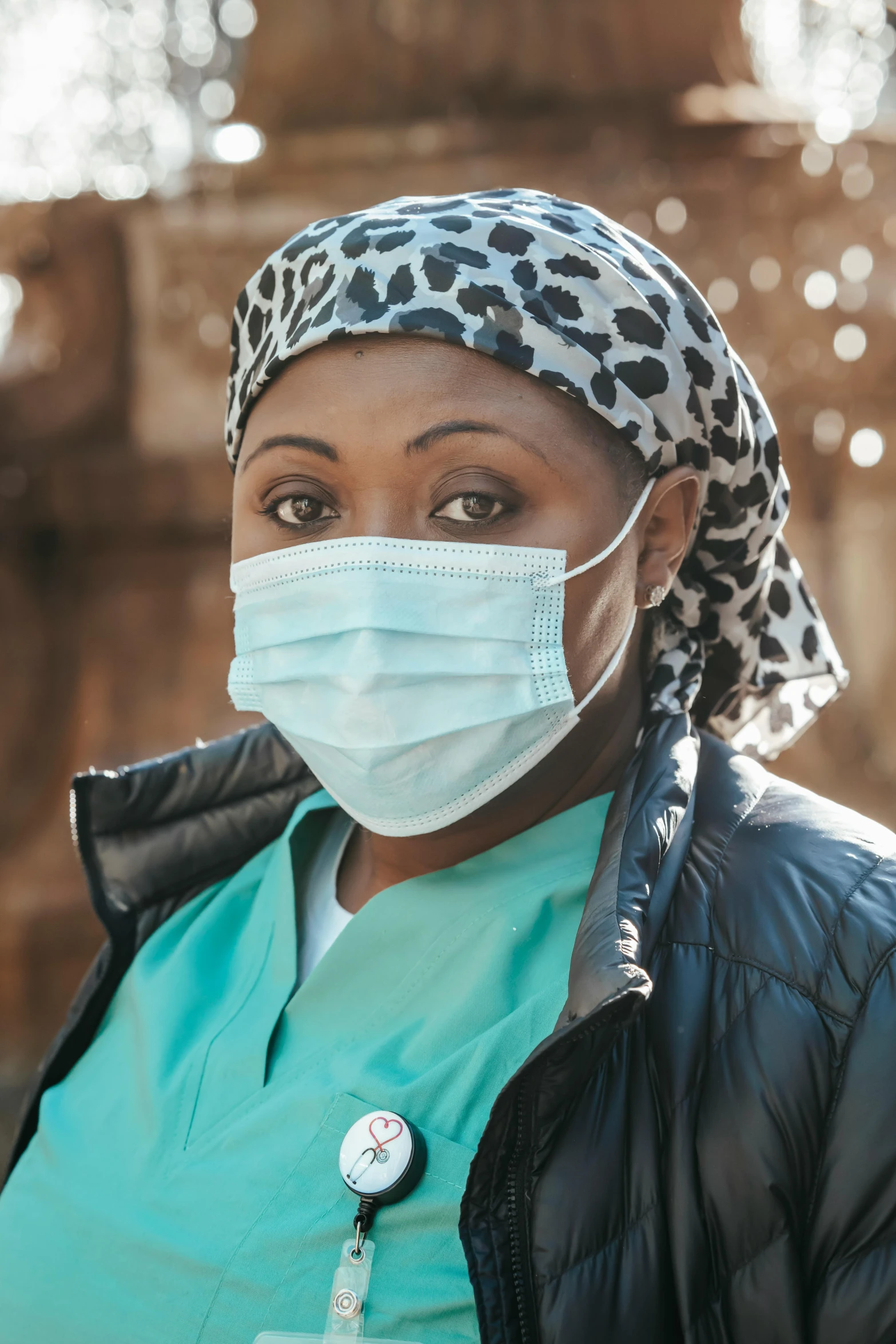 a close up of a person wearing a face mask, a portrait, in africa, nurse scrubs, somali woman, promo image