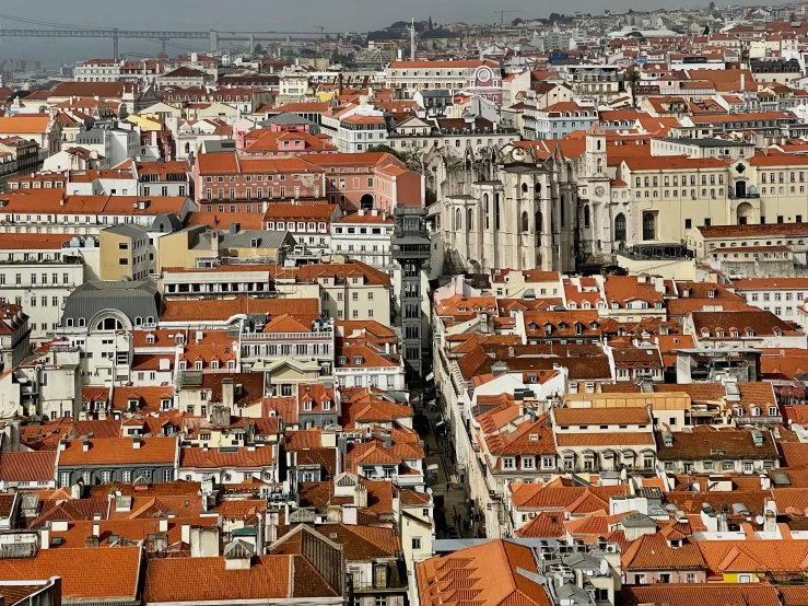 a view of a city from the top of a building, by Matija Jama, pexels contest winner, baroque, lisbon, thatched roofs, gray and orange colours, square
