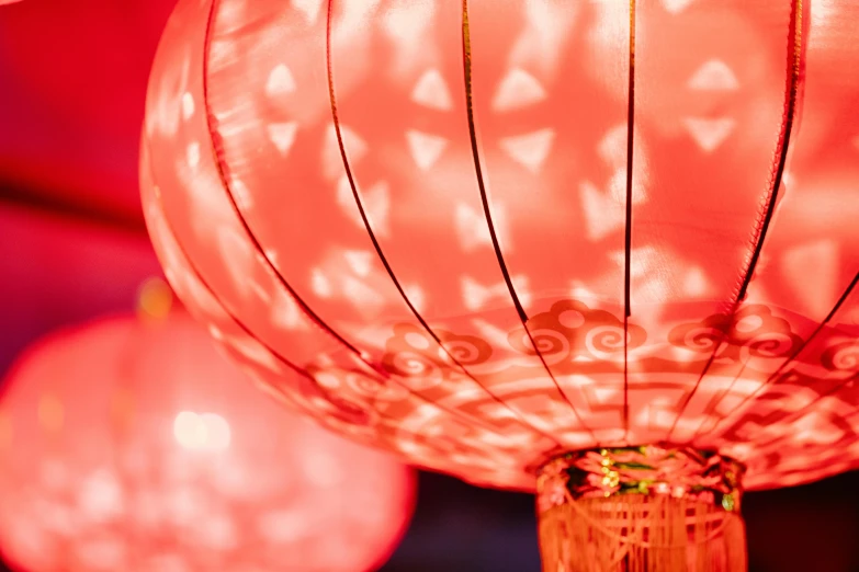 a group of red lanterns hanging from a ceiling, vibrant glow, up close, brilliantly coloured, oriental wallpaper