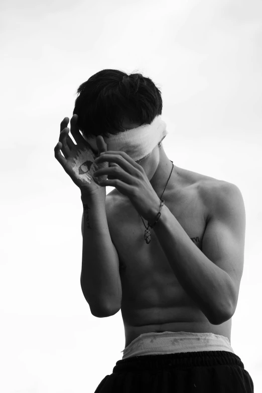 a man with a blindfold covering his face, a black and white photo, inspired by jeonseok lee, shirtless, alternate album cover, empty hands, julian ope