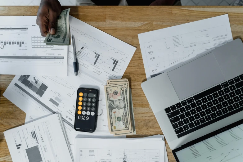 a laptop computer sitting on top of a wooden table, by Carey Morris, pexels contest winner, hurufiyya, piles of money, people at work, asset on grey background, charts