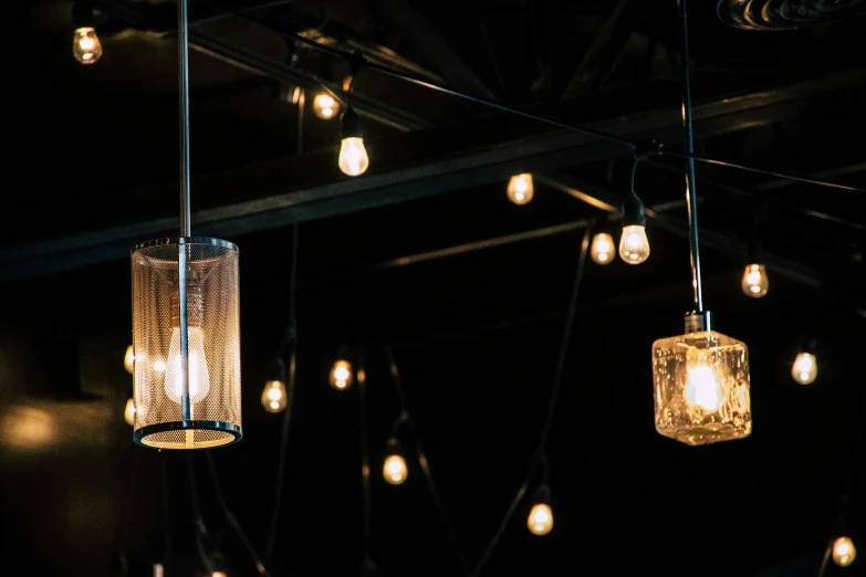 a bunch of light bulbs hanging from a ceiling, unsplash, light and space, two moons lighting, gothic lighting, an empty backroom at night, gas lighting