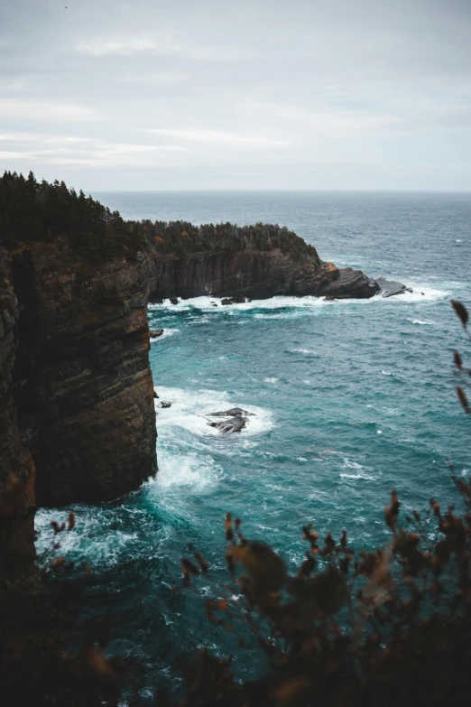 a large body of water next to a cliff, by Jessie Algie, pexels contest winner, wild ocean background, slide show, multiple stories, full frame image