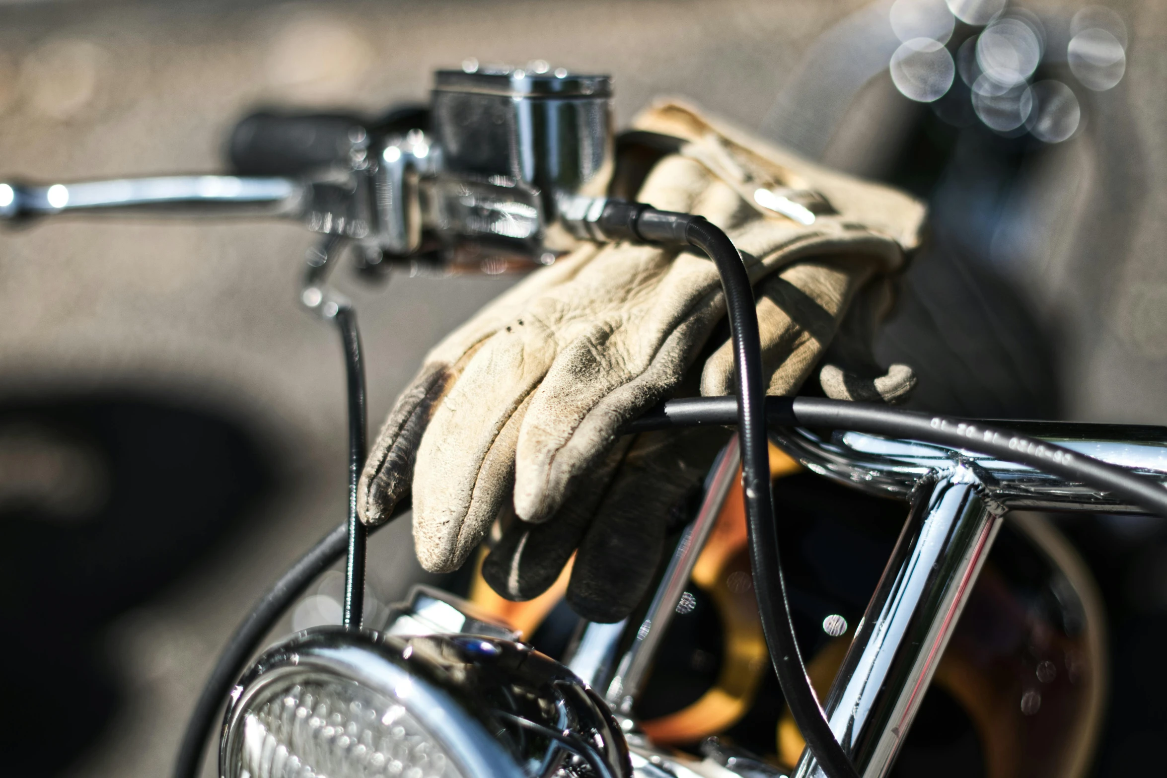 a glove on the handlebar of a motorcycle, a portrait, by Gavin Nolan, unsplash, ilustration, thick wires, 1 2 9 7, spare