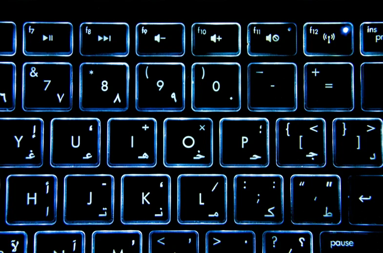 a close up view of a computer keyboard, by Andrei Kolkoutine, computer art, arabic, night light, glyphs, blue metal