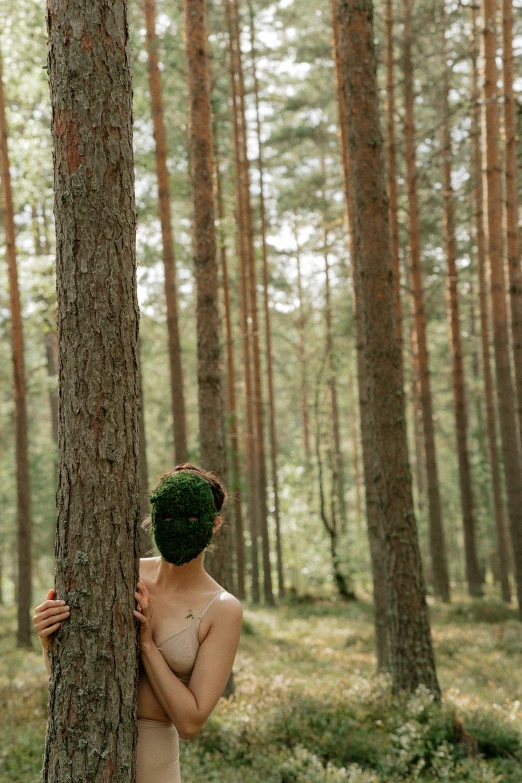 a woman hiding behind a tree in a forest, unsplash, conceptual art, erwin olaf, ((trees)), a photo of a man, summer season