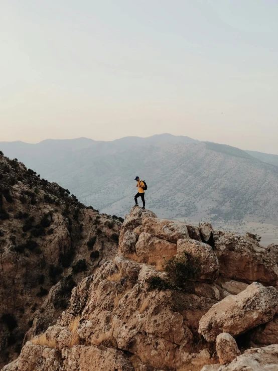 a person standing on top of a mountain, by Daren Bader, pexels contest winner, les nabis, jordan, walking to the right, profile shot, instagram story