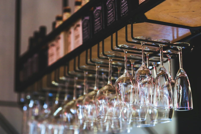 a bunch of wine glasses hanging from a rack, by Carey Morris, pexels, aussie baristas, iconostasis in the bar, thumbnail, close - up photo