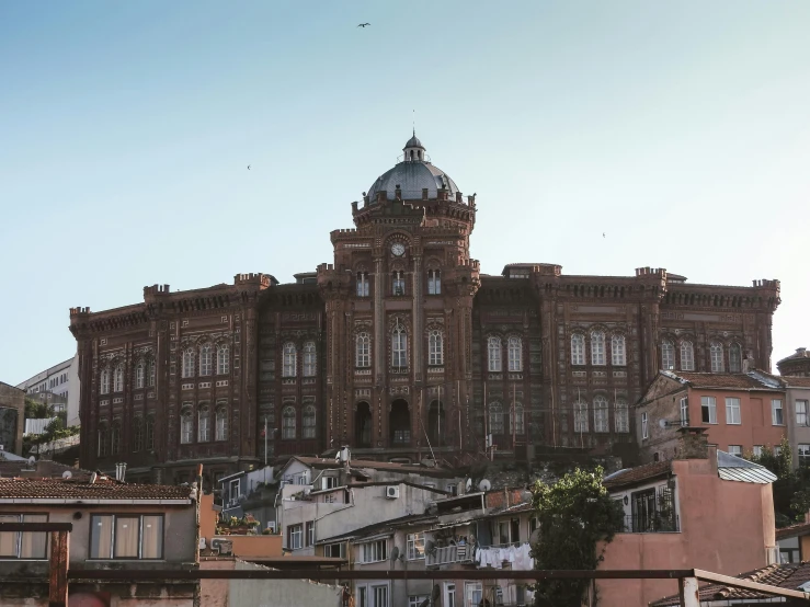 a large building sitting on top of a hill, pexels contest winner, renaissance, brick building, azulejo, in the middle of the city, profile image