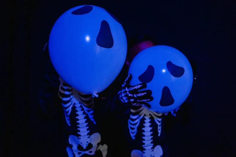 a couple of people that are holding some balloons, glowing bones, glowing blue face, shot with sony alpha 1 camera, zoom shot