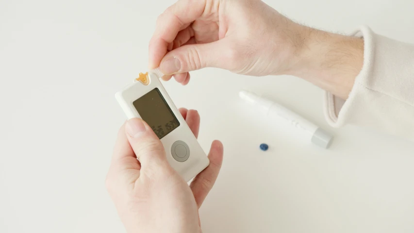 a close up of a person holding an electronic device, quack medicine, -step 50, miniaturecore, filling the frame