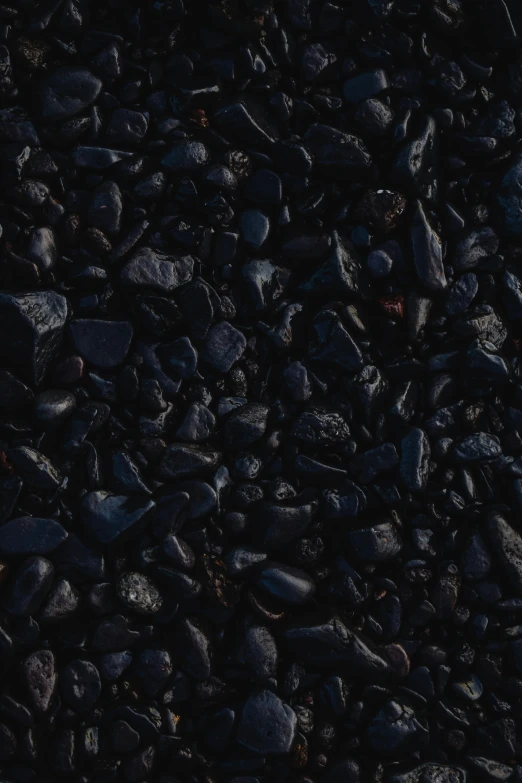 a red fire hydrant sitting on top of a pile of rocks, an album cover, by Jacob Toorenvliet, unsplash, made of smooth black goo, beans, midnight-blue, texture detail