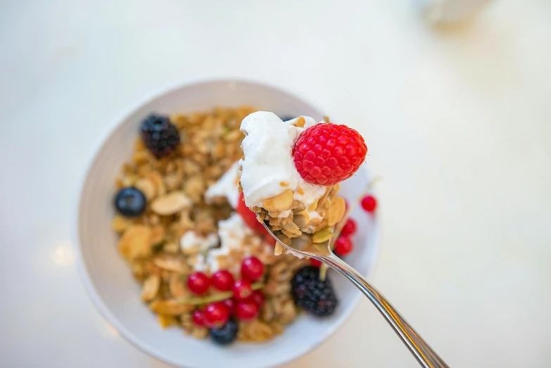 a bowl of cereal topped with berries and yogurt, by Matthias Stom, pexels, renaissance, 🎀 🗡 🍓 🧚, ivy's, mid view, orthodox