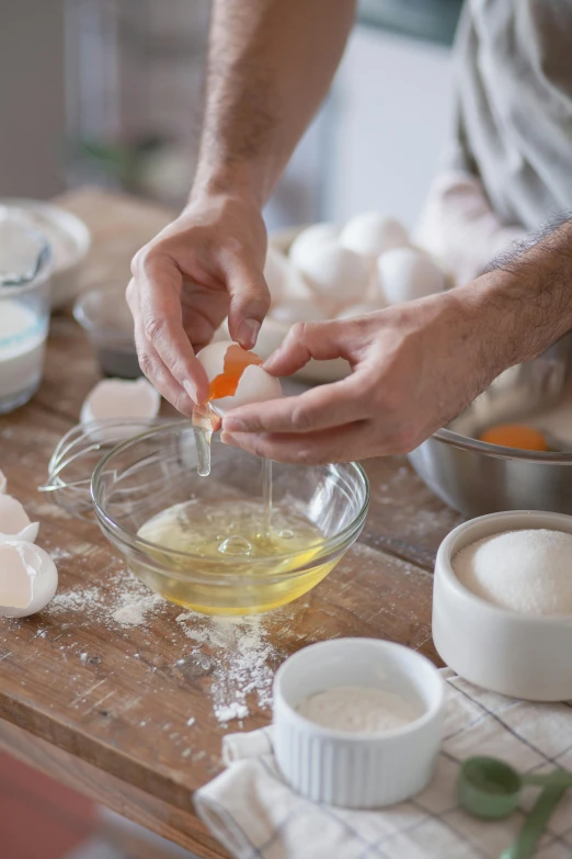 a person mixing ingredients in a bowl on a table, inspired by david rubín, eggs, bakery, essence, no cropping