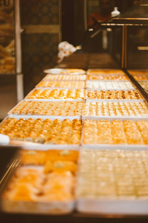 a number of trays of food on a table, pexels, arabesque, fresh bakeries in the background, caramel, thumbnail, slightly pixelated