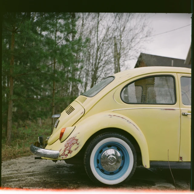 a yellow car parked on the side of a road, a polaroid photo, unsplash, photorealism, beetle, cottagecore hippie, scratches and burns on film, hasselblad photo