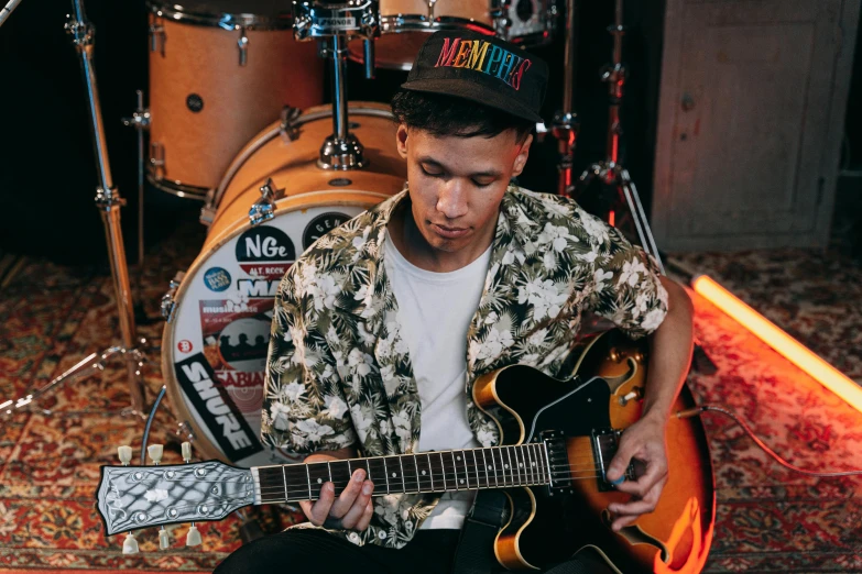 a man that is sitting down with a guitar, darren quach, with pop punk style, manuka, thumbnail