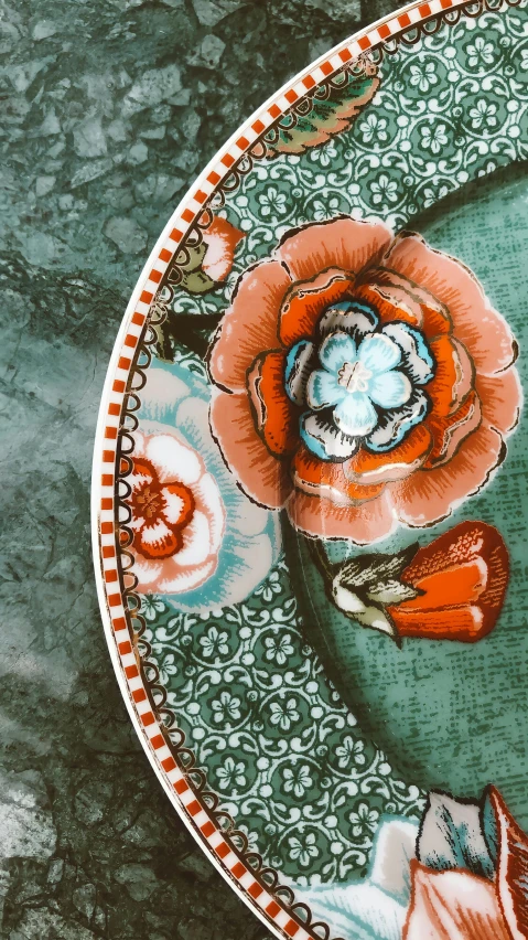 a close up of a plate with flowers on it, inspired by Elizabeth Shippen Green, instagram, baroque, teal and orange colours, payne's grey and venetian red, real porcelain texture effect, intricate lining