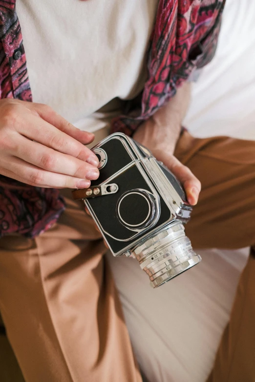 a man sitting on a couch holding a camera, unsplash, photorealism, flasks, hibernation capsule close-up, hero shot, close up shot from the side