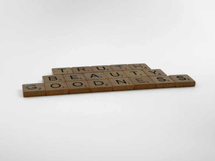 scrabble tiles spelling truth, beauty and goodness, an album cover, conceptual art, rendered in cinema4d, ( ( brown skin ) ), detailed product image, concrete poetry